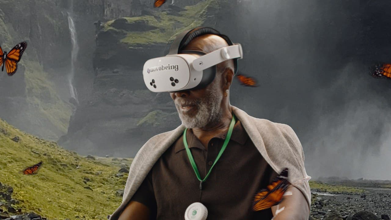 Patient wearing a Novobeing VR headset with a calm mountain waterfall and butterflies around him.