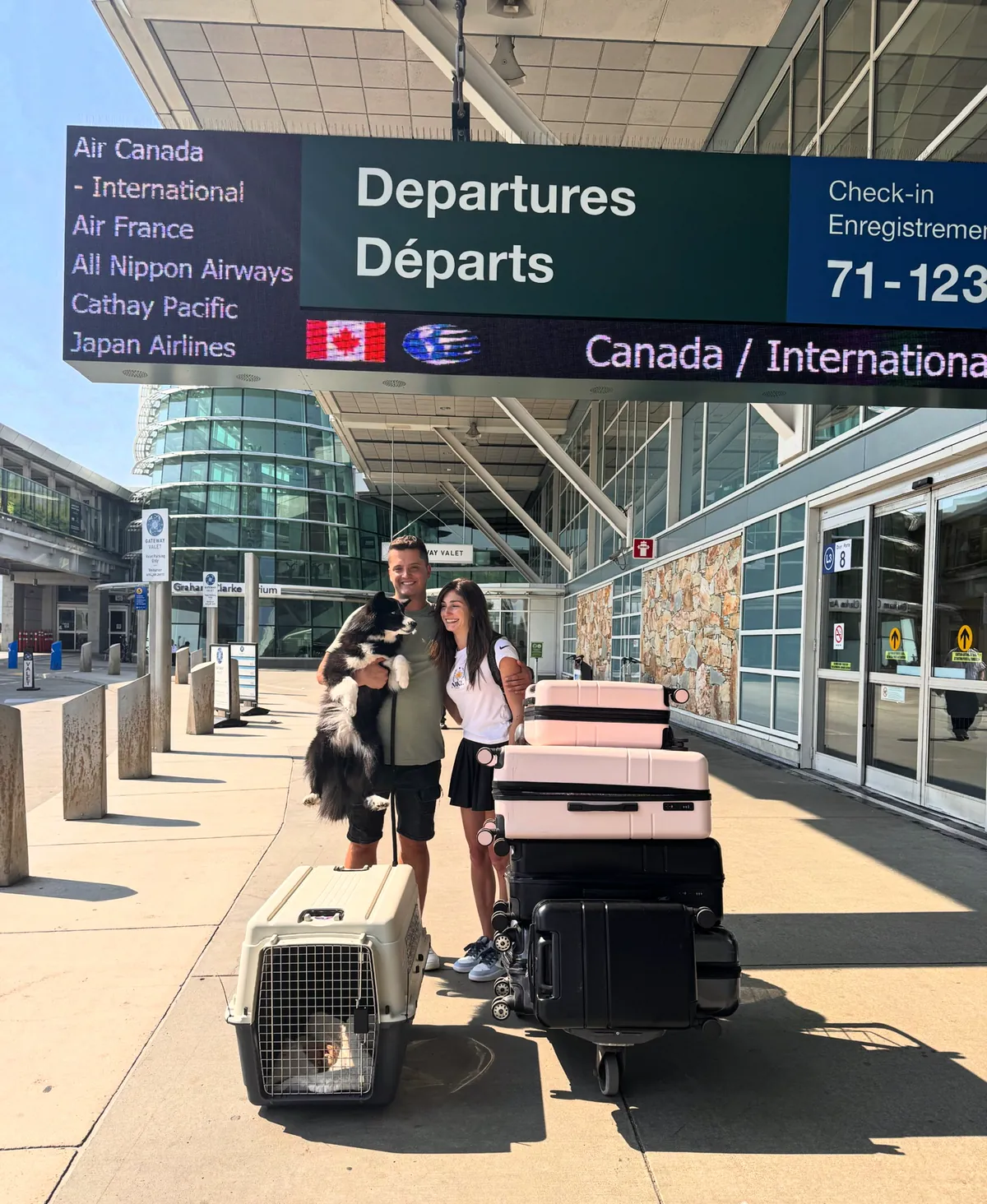 Nik, his girlfriend and their dog at the airport leaving Canada
